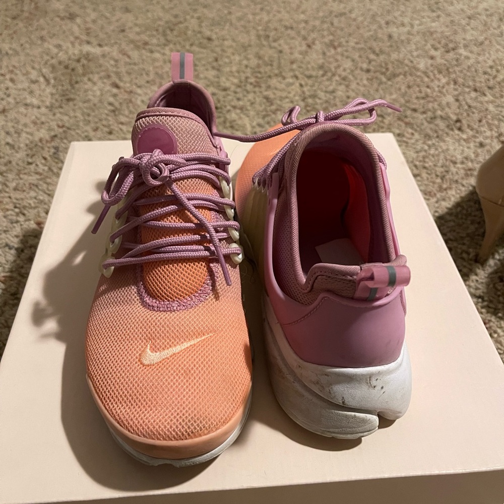 Pink and purple Nike tennis shoes